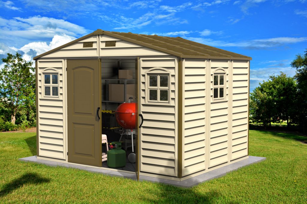 Duramax WoodSide 10.5x8 vinyl storage shed installed in a backyard setting