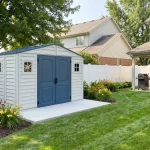 RidgeLine 10.5' x 5' vinyl shed installed in a landscaped backyard beside a lawn and patio